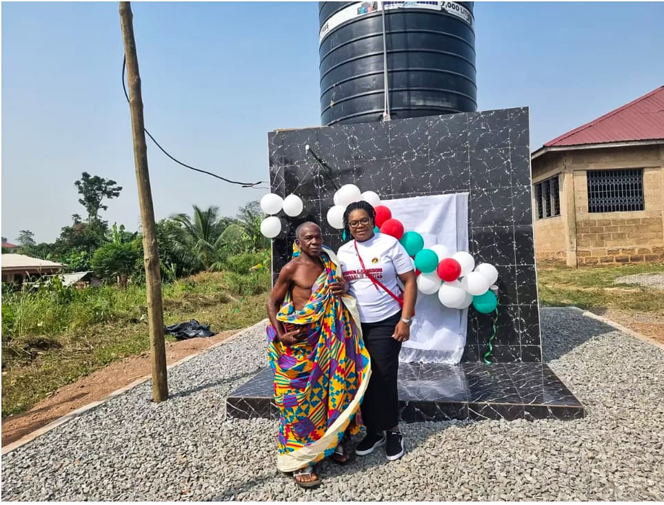 Mrs. Hannah Brock with a community chief at the commissioned borehole and water tank