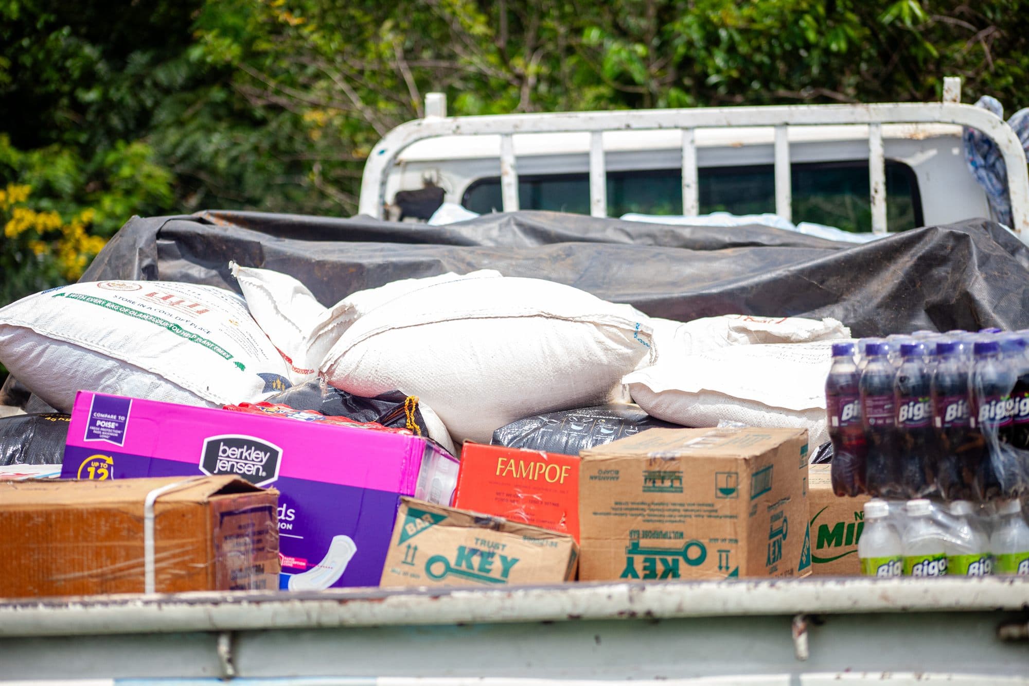 A pickup truck loaded with donated bags of food and supplies ready for delivery