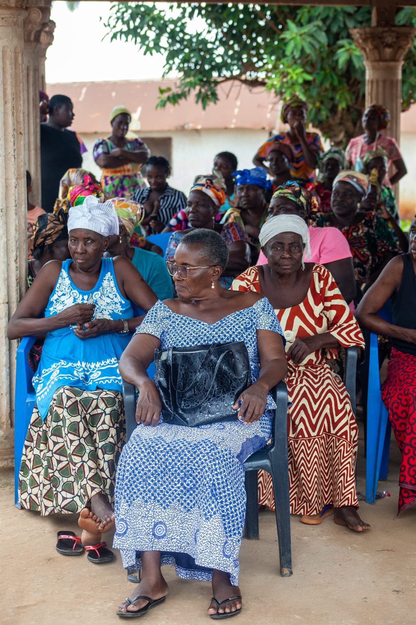 Women of the community seated together at an outreach gathering