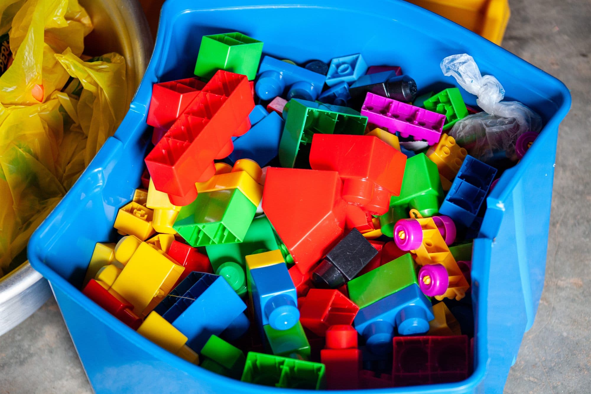 A tub of colourful building blocks and toys donated for children