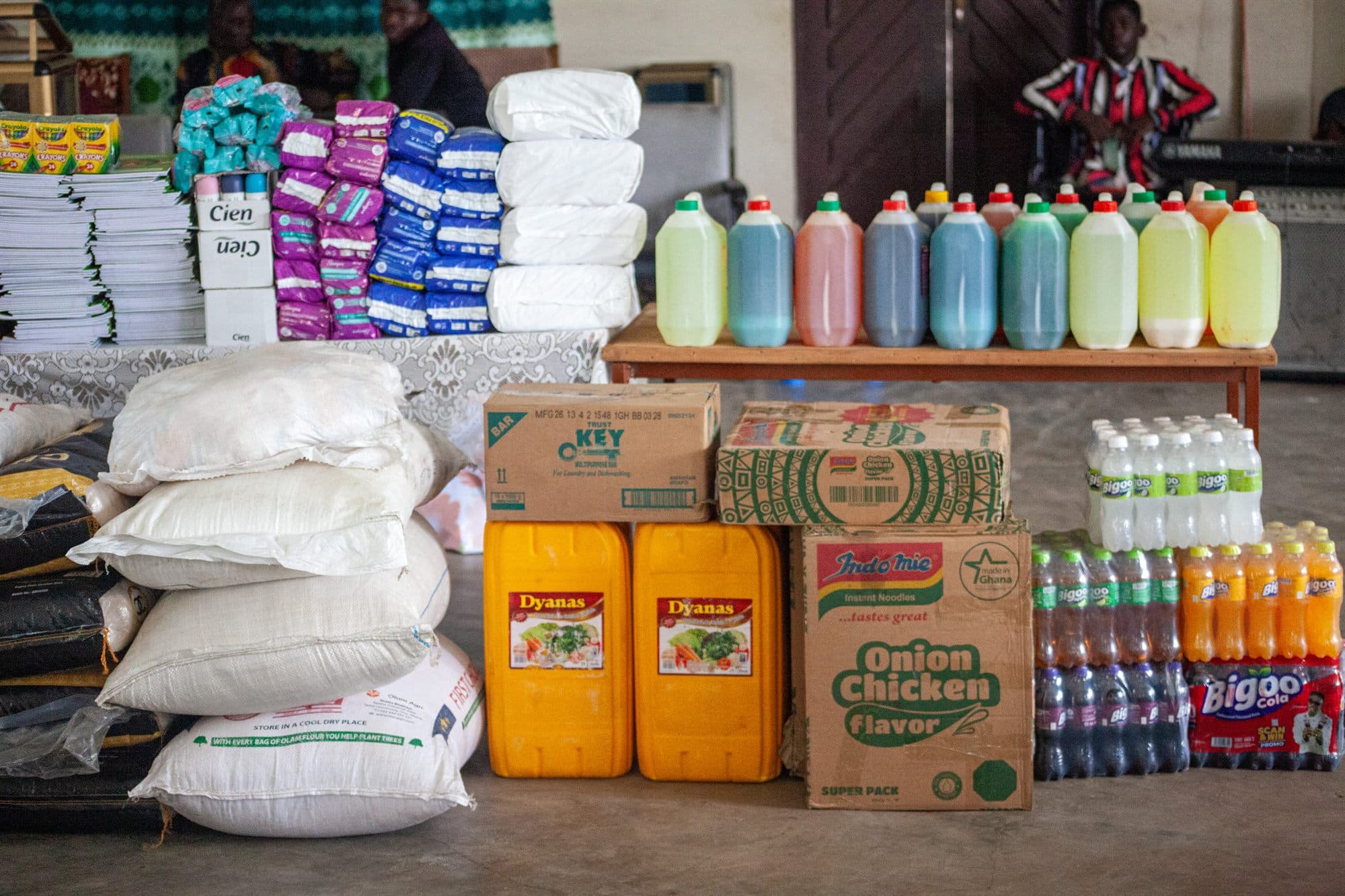 Donated food, toiletries and school supplies laid out for a distribution day
