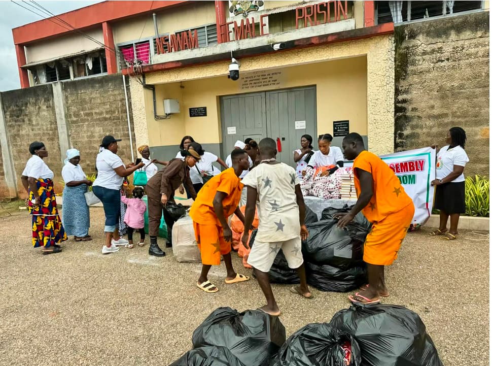 Inmates carrying bags of donated supplies at Nsawam Female Prison during a Women of the Kingdom outreach