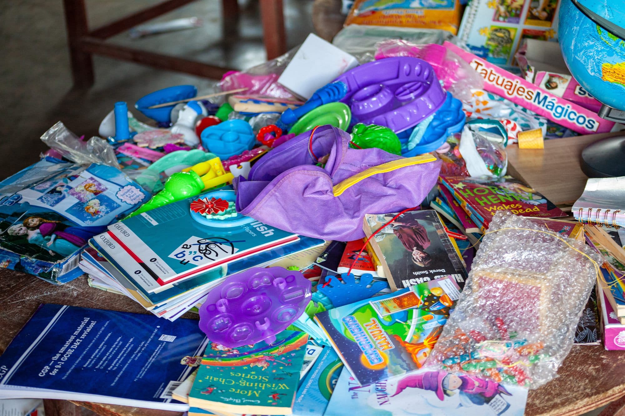 Toiletries, books and everyday supplies laid out for distribution