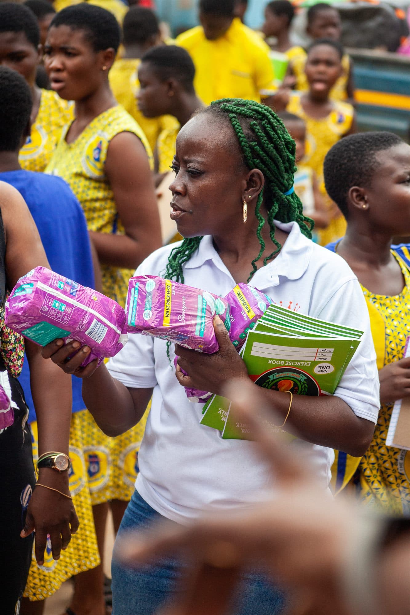 A volunteer sharing sanitary and personal-care items with the community