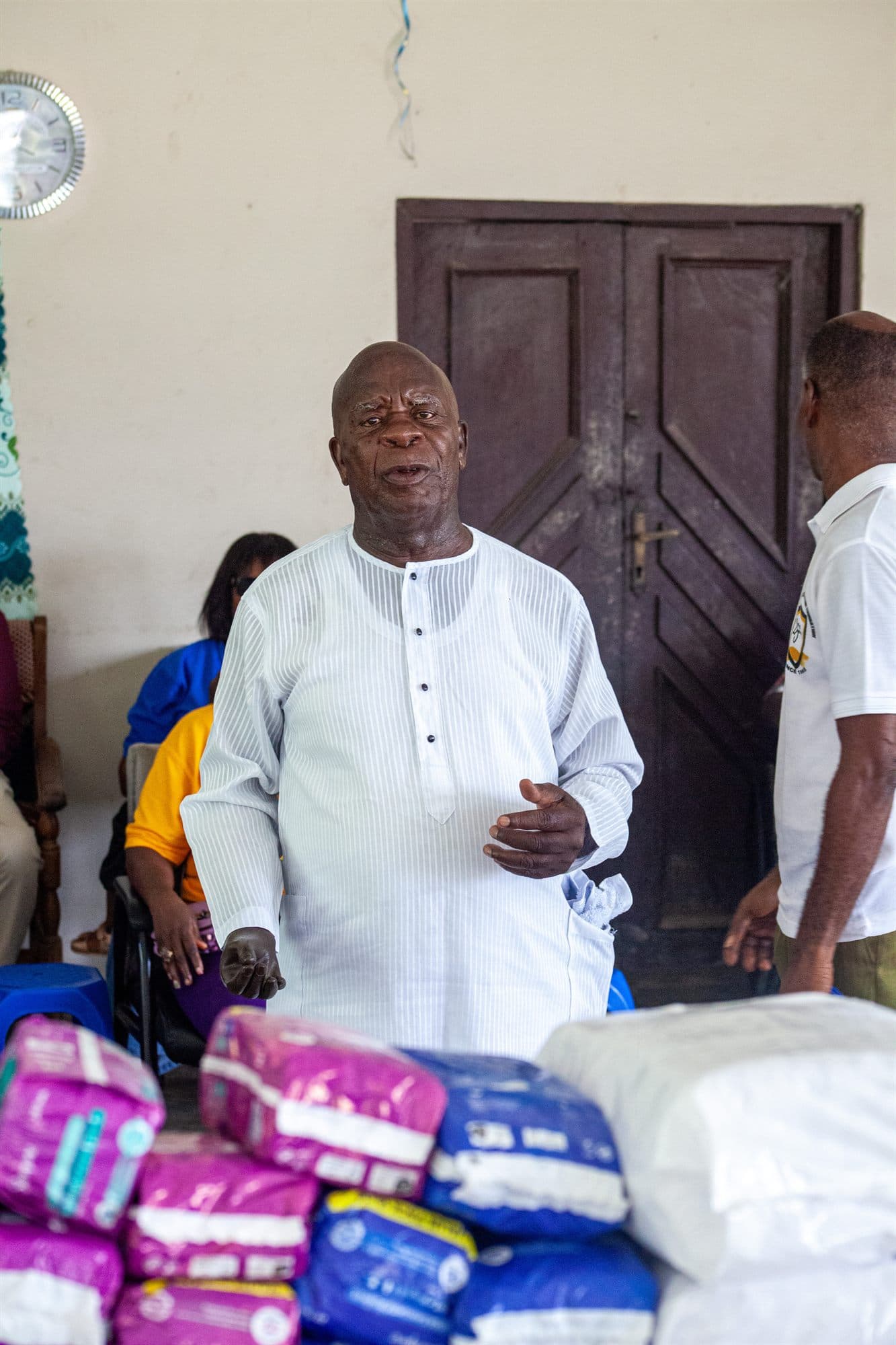 An elderly community member receiving donated personal-care items