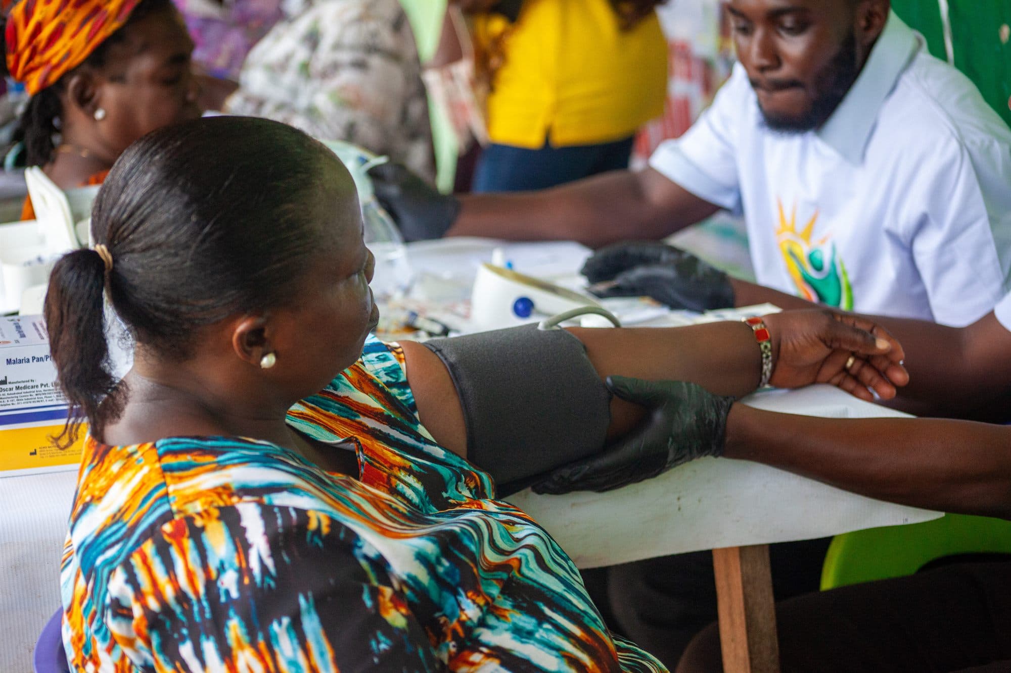 A community member having her blood pressure checked at a Women of the Kingdom health screening