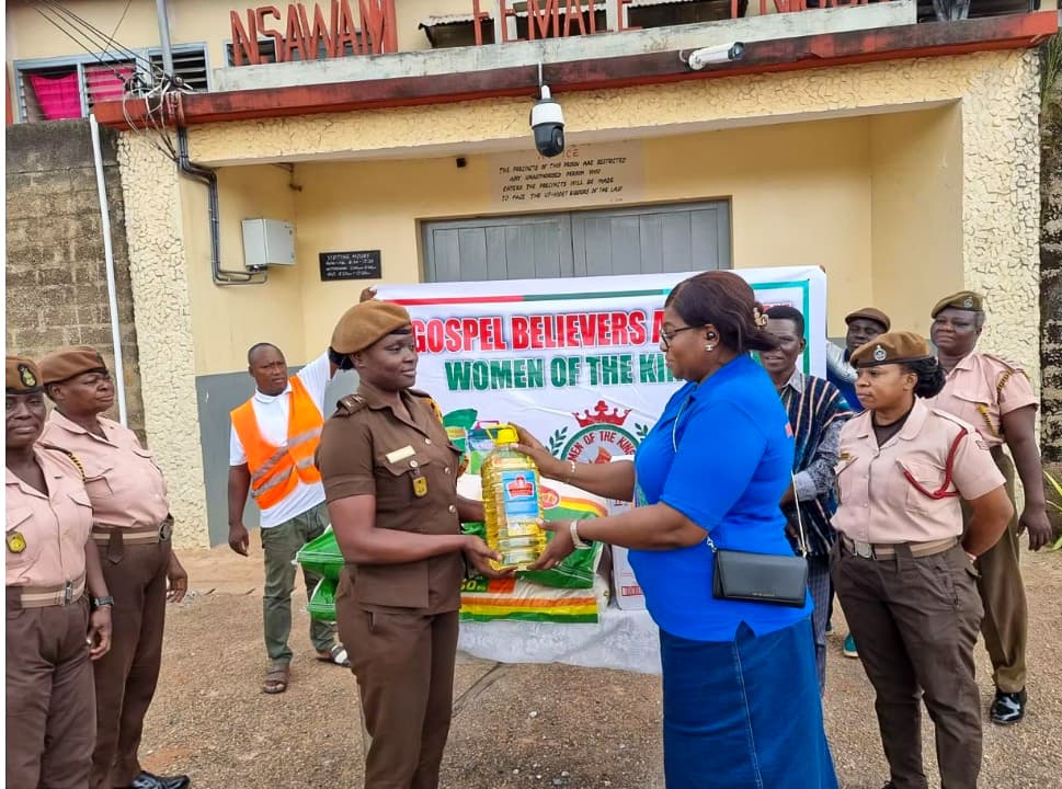 Mrs. Hannah Brock handing food and supplies to an officer at Nsawam Female Prison
