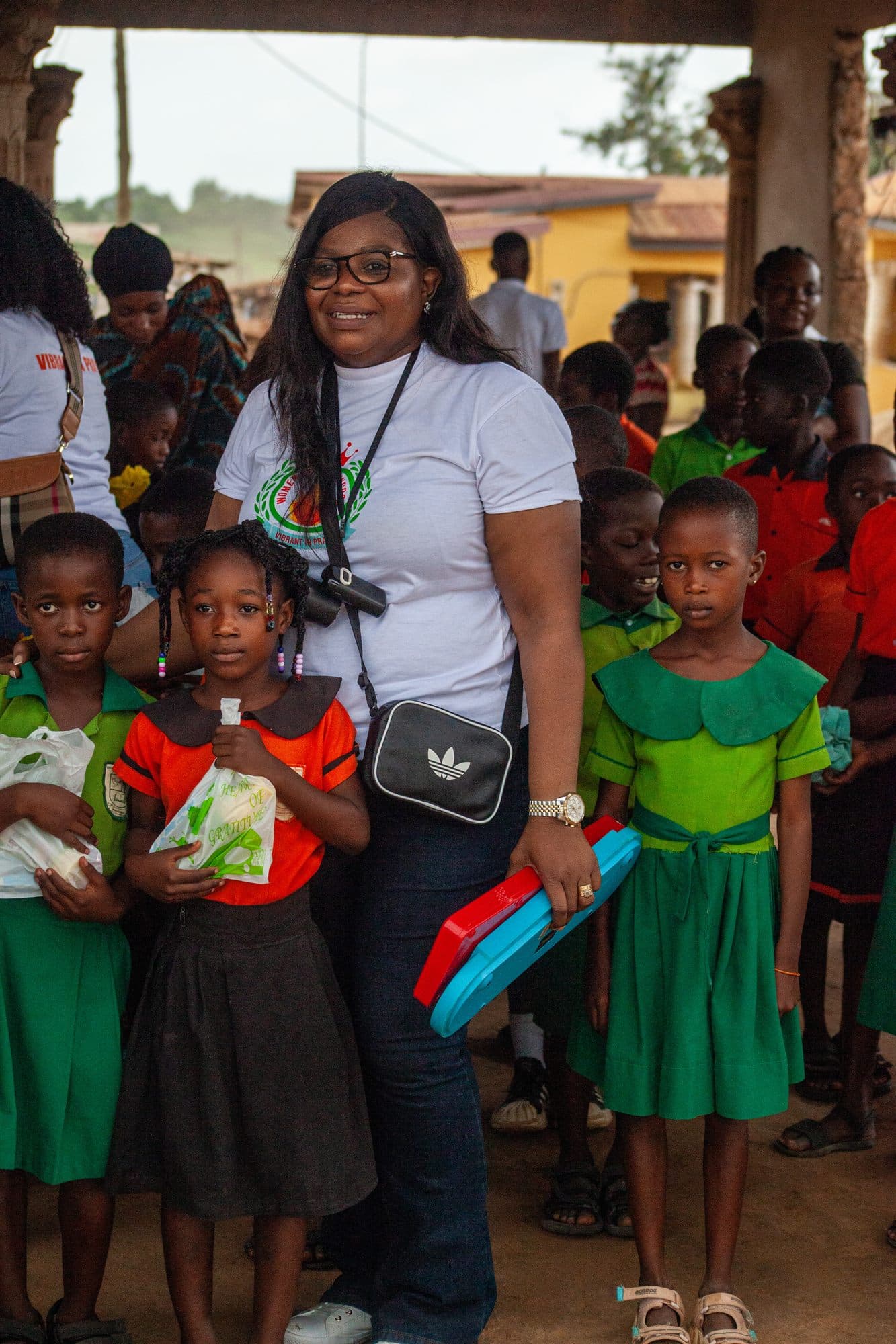 A volunteer spending time with children at a community visit