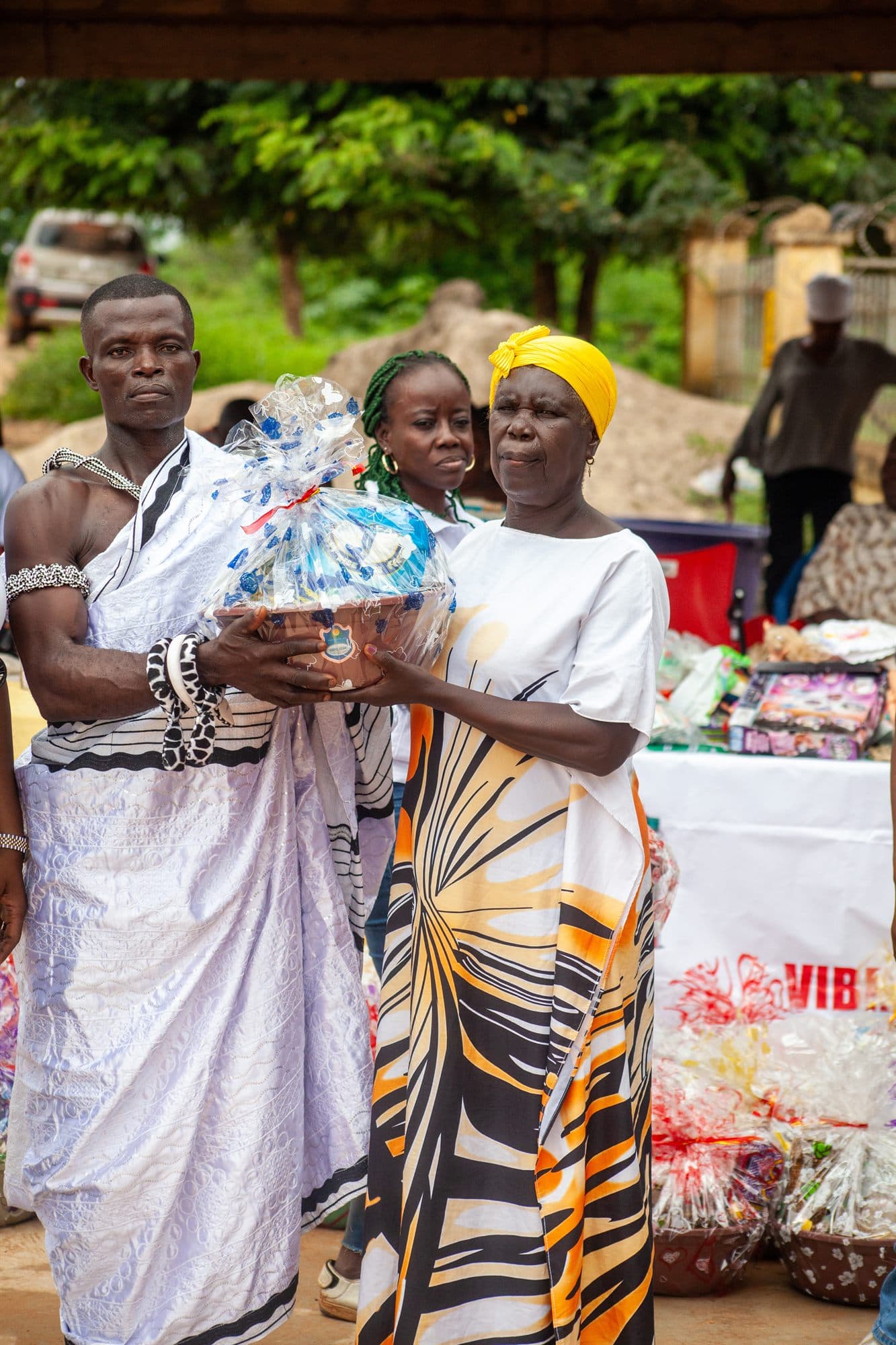 A woman holding the wrapped gift hamper she has just received